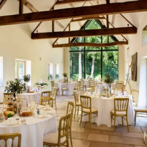 Photography of the barn interior prior to the wedding breakfast at Hampden House in Buckinghamshire