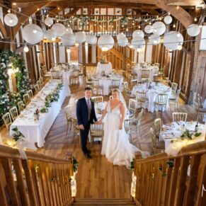 Photography from the balcony of this barn interior including the newlyweds prior to the wedding breakfast at this grand Buckinghamshire venue