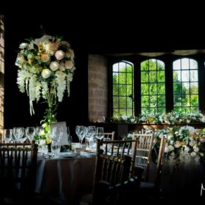 Artistic photography of the barn interior and floral arrangements prior to the wedding breakfast at this fabulous Buckinghamshire venue