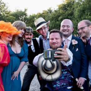 Selfie photography time for some wedding guests with the groom enjoying the party vibe at this fabulous Buckinghamshire barn location