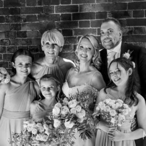 Arty black and white photography of bride and groom with the their bridesmaids at their historic Buckinghamshire wedding venue