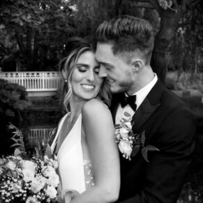 Black and white photography of bride and groom enjoying a snuggle at their Buckinghamshire marquee wedding