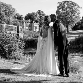 Dramatic black and white photography of bride and groom next to the lake at their Hartwell House Buckinghamshire wedding