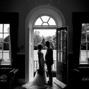 Black and white wedding photography of bride and groom enjoying a romantic moment at their Bisham Abbey Buckinghamshire venue