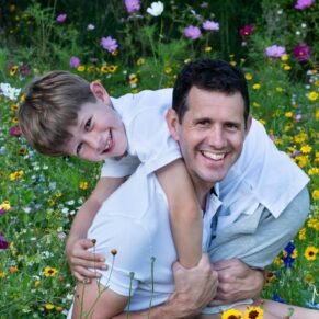 Relaxed father and son portrait photography in a colourful Buckinghamshire wild flower meadow