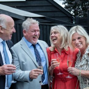 Photography of some guests giggling away at this Buckinghamshire pub wedding drinks reception