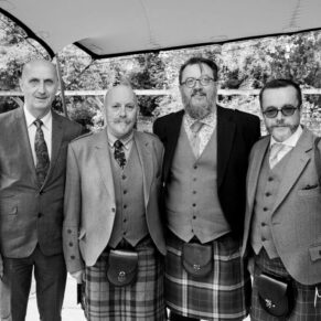 Photography of some friends in the courtyard prior to the civil wedding ceremony at Badgemore Park in Henley on Thames