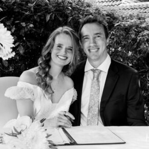 Photography of the newlyweds signing the register at their outdoor wedding ceremony at Fredrick's Hotel in Maidenhead