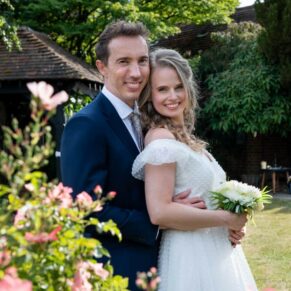 Photography of the bride and groom posing for a romantic portrait in the stunning gardens at their Fredrick's Hotel wedding in Berkshire