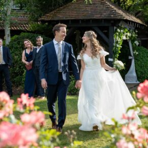 Photography of the bride and groom walking in the beautiful gardens at their Fredrick's Hotel wedding