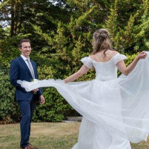 Photography of the bride spinning around in the gardens at Fredrick's Hotel in Maidenhead on her wedding day
