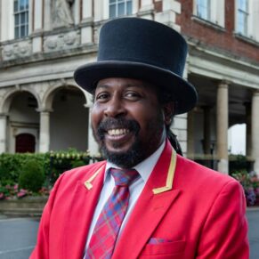 Photography of the Macdonald Windsor Hotel's doorman before he greeted the wedding guests at the entrance