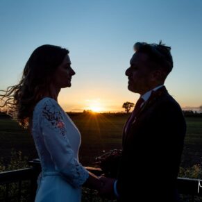 Sunset silhouette photography of the bride and groom at their Winters Tale Country Barn wedding venue in Buckinghamshire