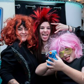 Winters Tale Country Barn wedding photography of some of the evening guests enjoying the photo-booth with their various wigs and props