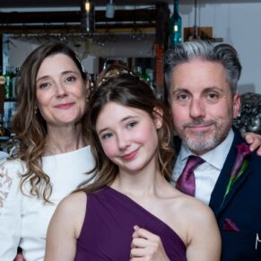 Winters Tale Country Barn wedding photography of the bride and groom with their daughter during the evening reception