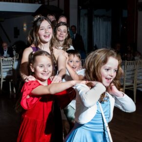 Winters Tale Country Barn wedding photography of the evening reception getting pretty lively with a conga line dance from these smiling ladies