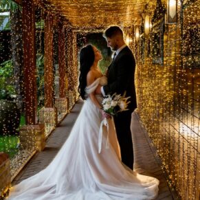 Relaxed silhouette photography pose of the newlyweds in the illuminated light tunnel at their Crazy Bear Hotel wedding in Stadhampton